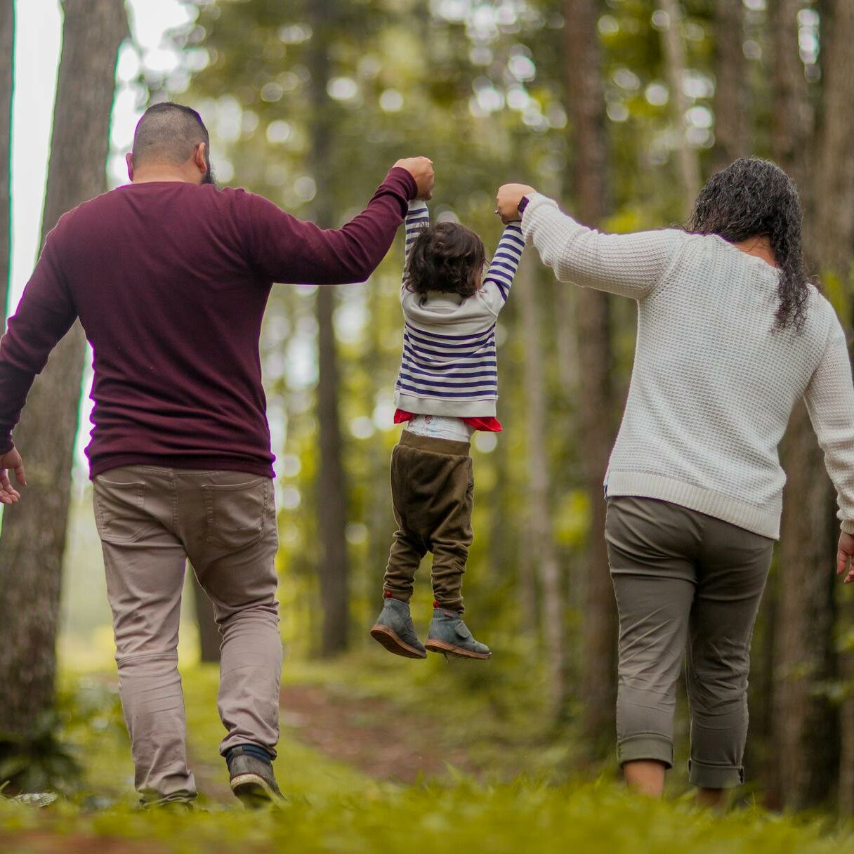 Parents lifting up child