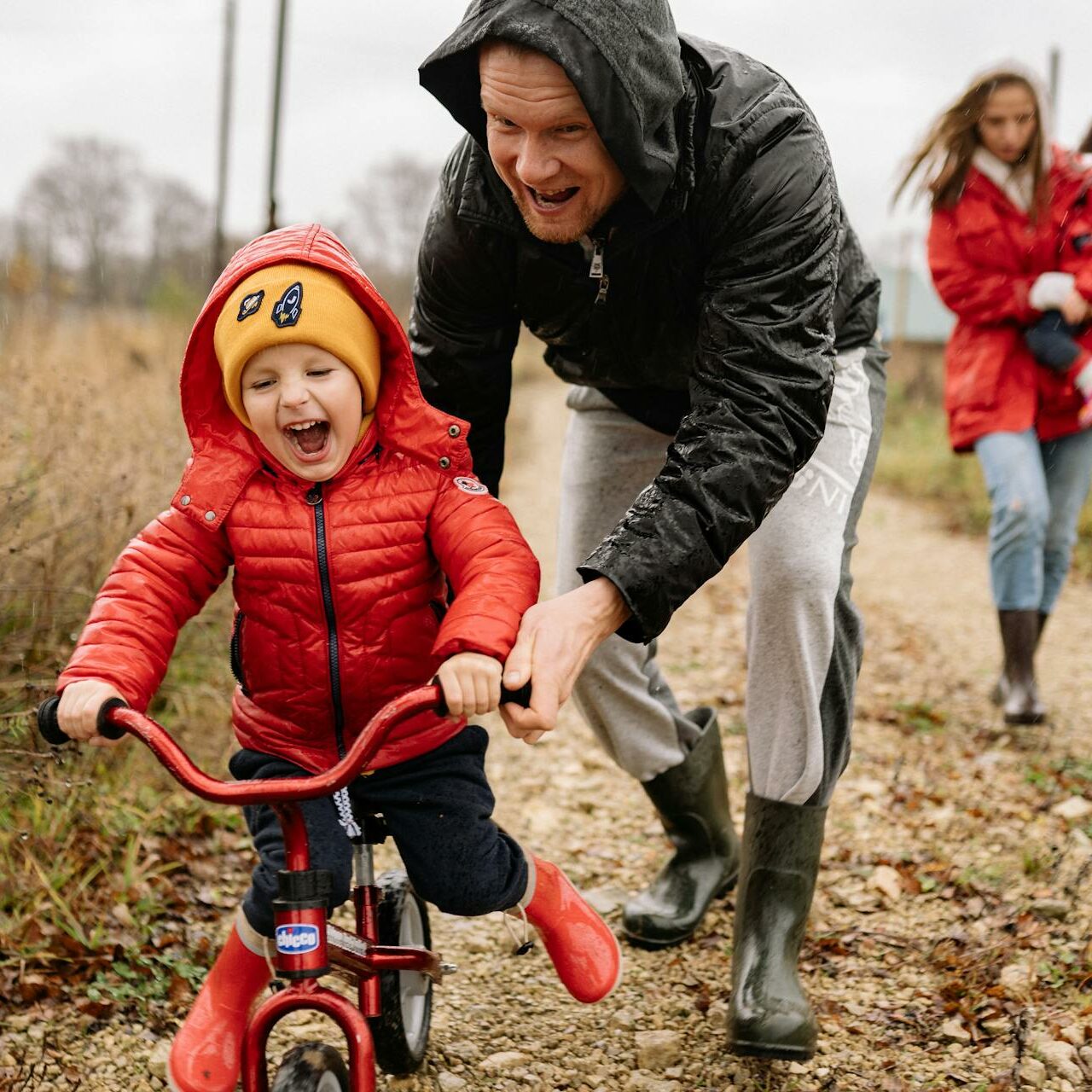 Dad helping little boy ride a bike